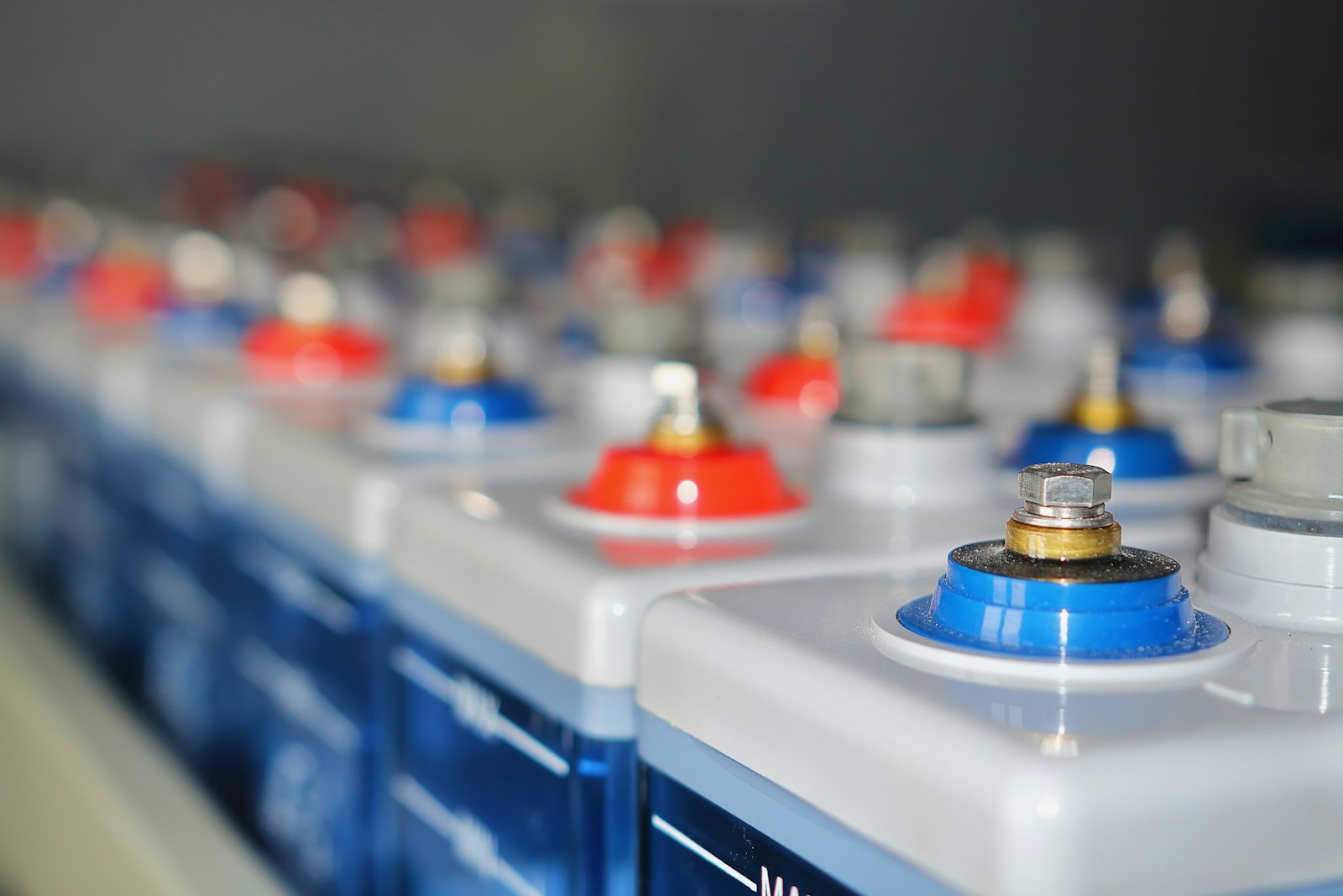 Close-up of battery terminals on a row of batteries