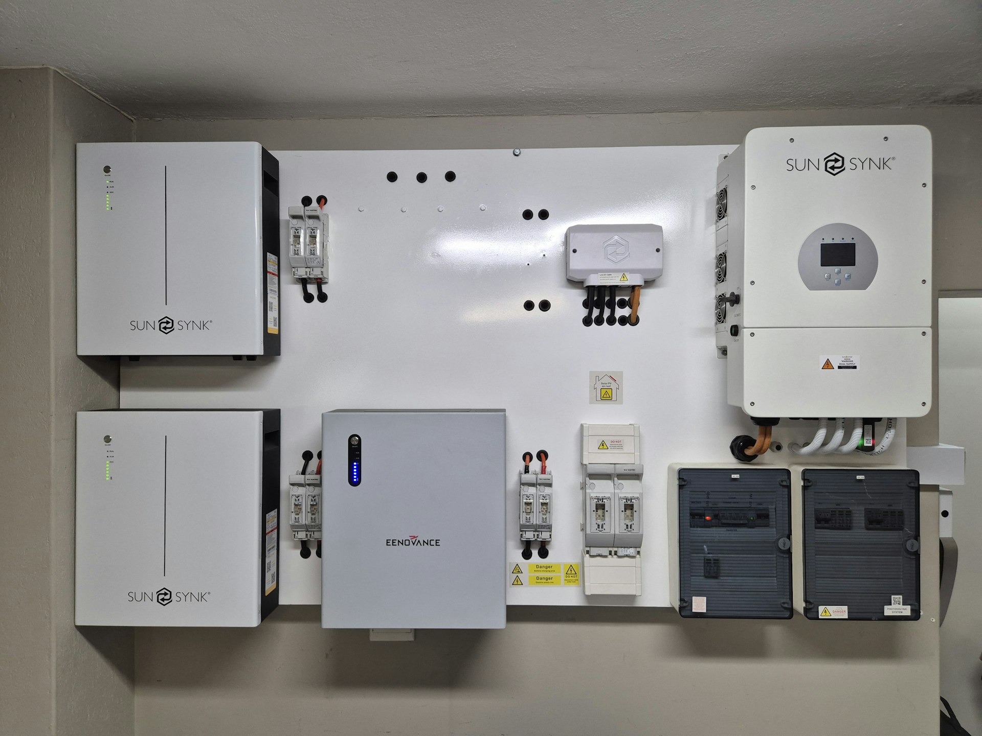 Inverter beeping: a wall-mounted inverter and battery system with its display and breakers